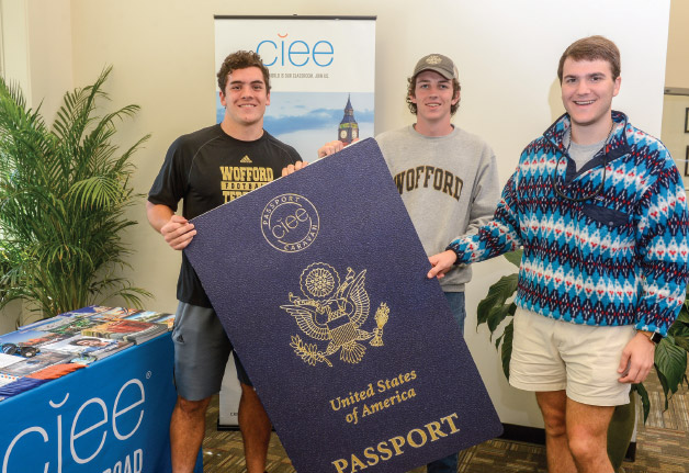 Students holding large passport