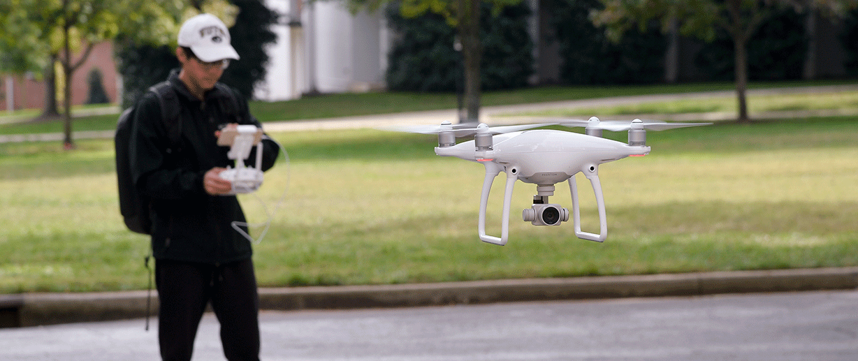 Student Jeremy Powers flies his drone on campus for his business.