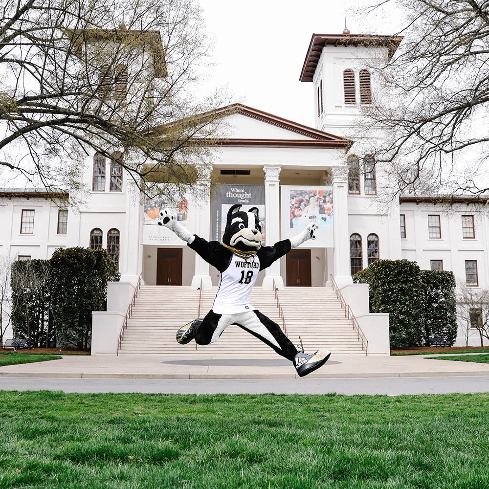 Wofford mascot, Boss, jumping in front of Main Building